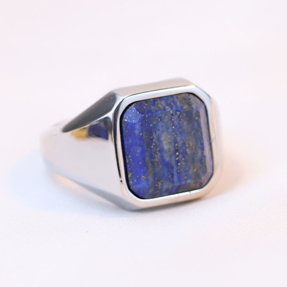 Blue lapis lazuli square stone signet ring on a hand with a stainless steel band