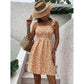 Close view of the ditsy floral print and ruffled shoulder straps on the mini dress