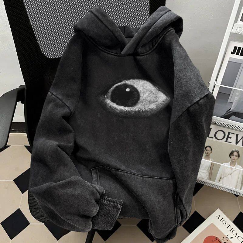 Detail of the printed eye and faded black knit on the hoodie