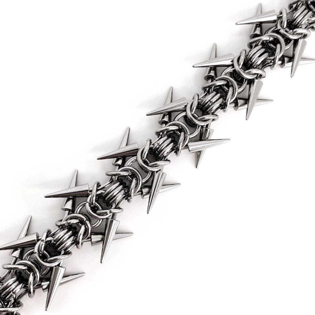 Spiked chainmail cuff bracelet shown on the arm in a silver tone finish