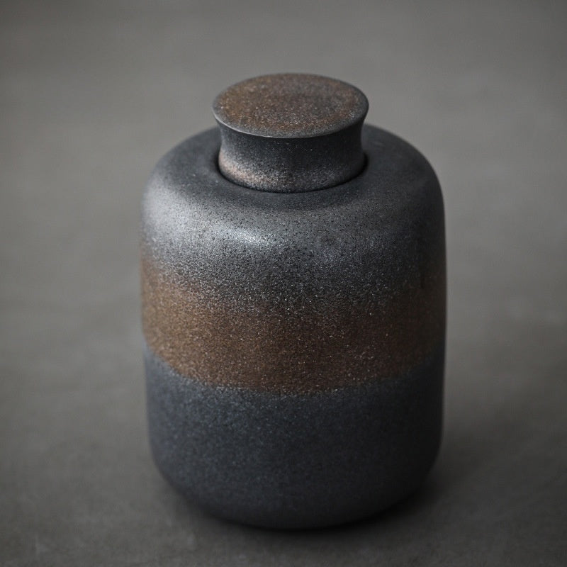 Glazed ceramic storage jar with the lid lifted to show the sealing rim