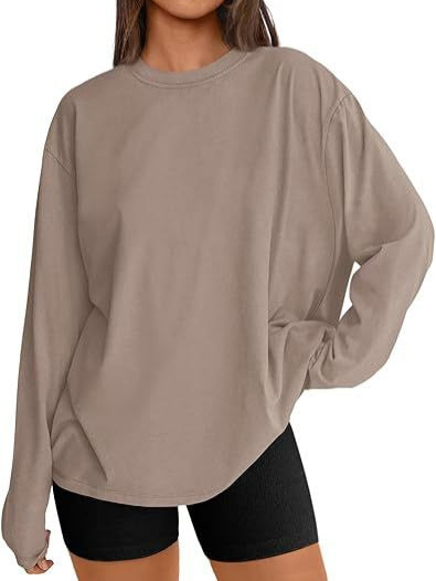 Khaki loose fit long sleeve crew neck rayon top worn with black bike shorts, front view