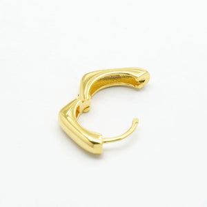 Side view of a gold huggie hoop showing the open hinged snap closure