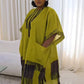 Chartreuse boubou kaftan dress with beaded neckline and fringed hem seen in a three quarter standing view
