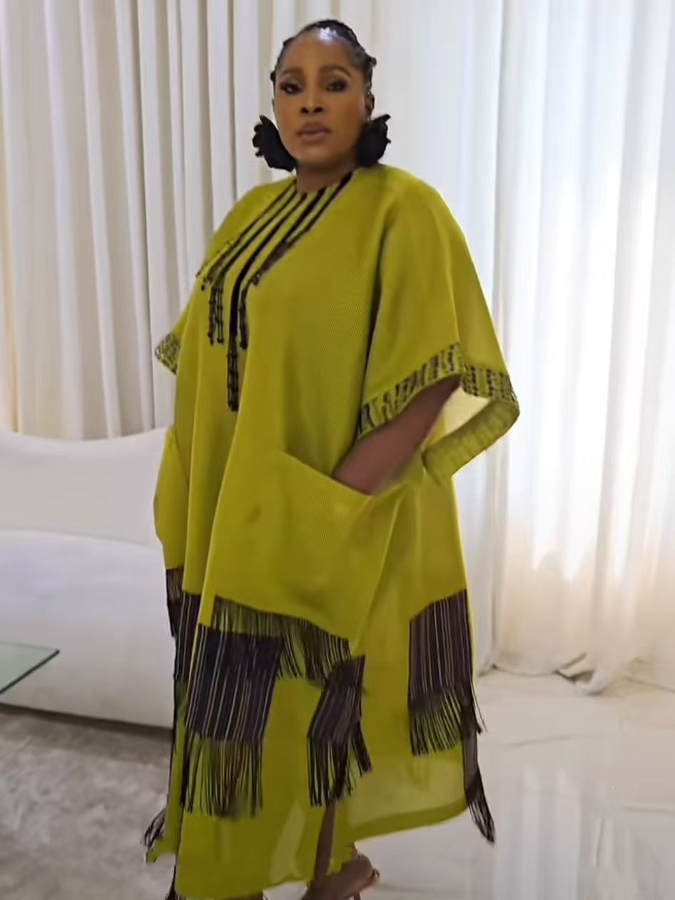 Chartreuse boubou kaftan dress with beaded neckline and fringed hem seen in a three quarter standing view