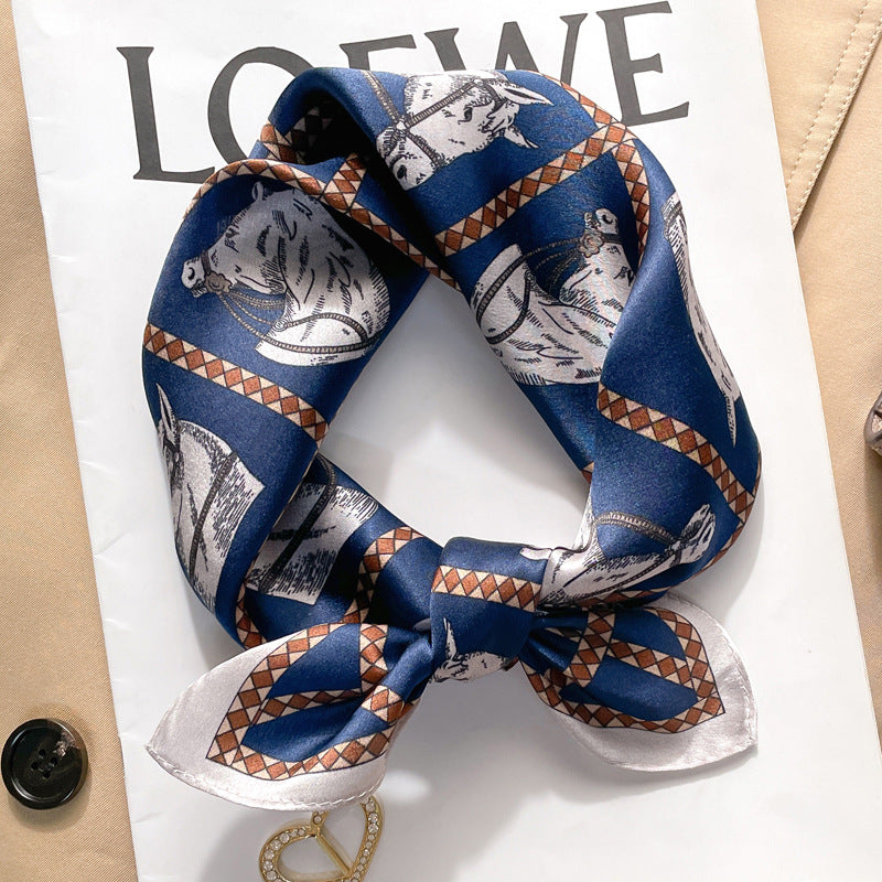 Navy and orange equestrian printed square scarf with a satin sheen and hemmed edges, shown displayed