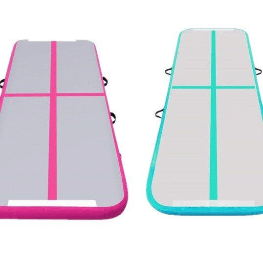 Pink and mint green inflatable gymnastics air track mats with a gray top, cross stripes and carry handles