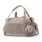 Brown nylon diaper bag tote seen from the front with its shoulder strap and braided quilt front pocket