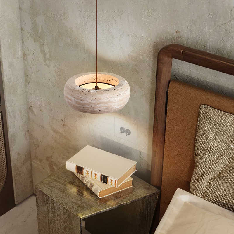 Natural travertine pendant shade with visible banding and open pores casting light up and down