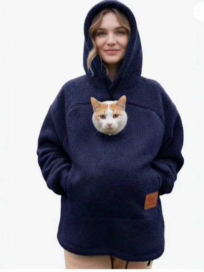Navy blue fleece pet pouch hoodie on a woman with a cat riding in the front pouch