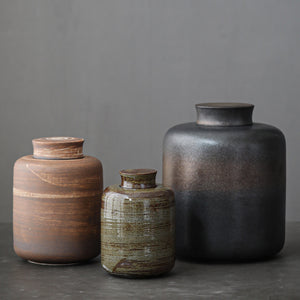Ceramic storage jar with custom logo, front view of the glazed stoneware body