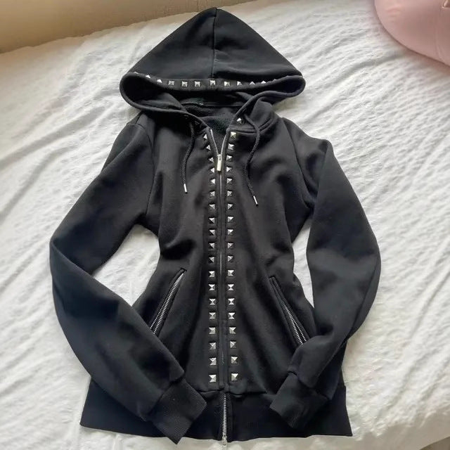 Black slim-fit zip-up hoodie laid flat with silver pyramid studs on the hood rim and down the front zip