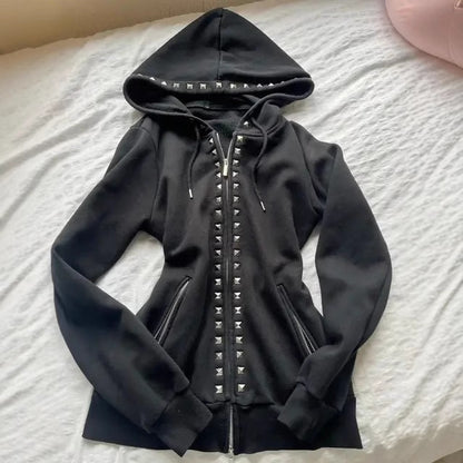 Black slim-fit zip-up hoodie laid flat with silver pyramid studs on the hood rim and down the front zip