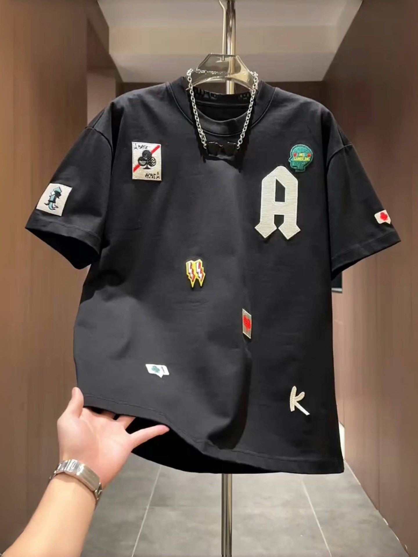 Men's loose fit embroidered patch T-shirt in white with a varsity A letter and sewn on patches