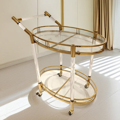 Gold stainless steel two tier serving cart with oval glass shelves and clear acrylic legs