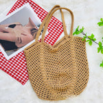 Cotton crochet tote bag folded flat showing its soft open weave