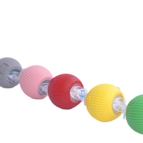 Red rolling pet ball avoiding a table leg while a small terrier chases it indoors