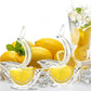Clear bird lemon juicers among fresh lemons, mint, and a tall iced drink on a bright table