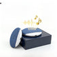 Two light blue sleep speakers beside a plain navy retail box on white