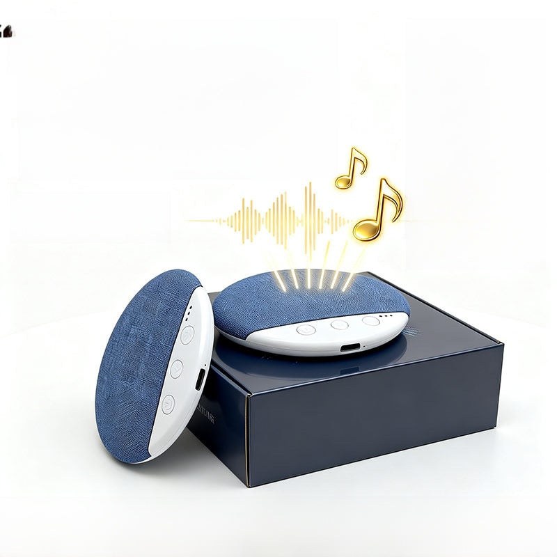 Two light blue sleep speakers beside a plain navy retail box on white