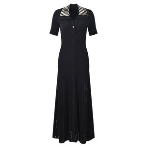Black knit dress shown flat from the front with the buttoned placket and beaded collar