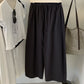 Carbon ash cotton wide leg trousers with drawstring waist on a hanger