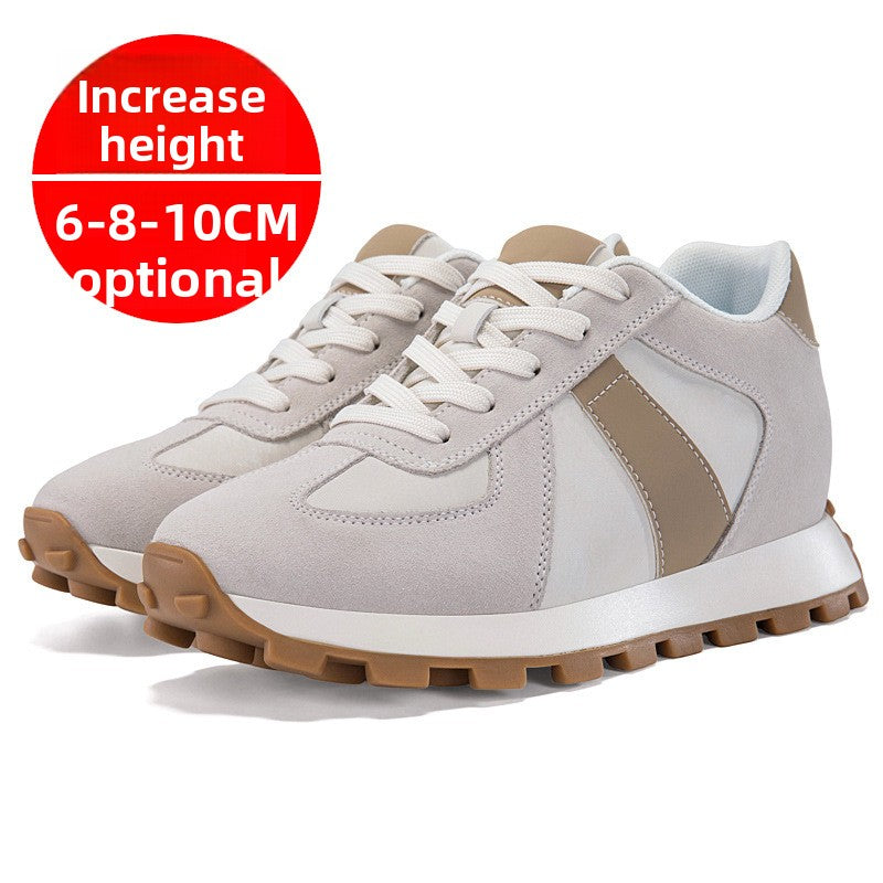 Pair of light gray low top sneakers with off-white laces and a taupe stripe on a white background