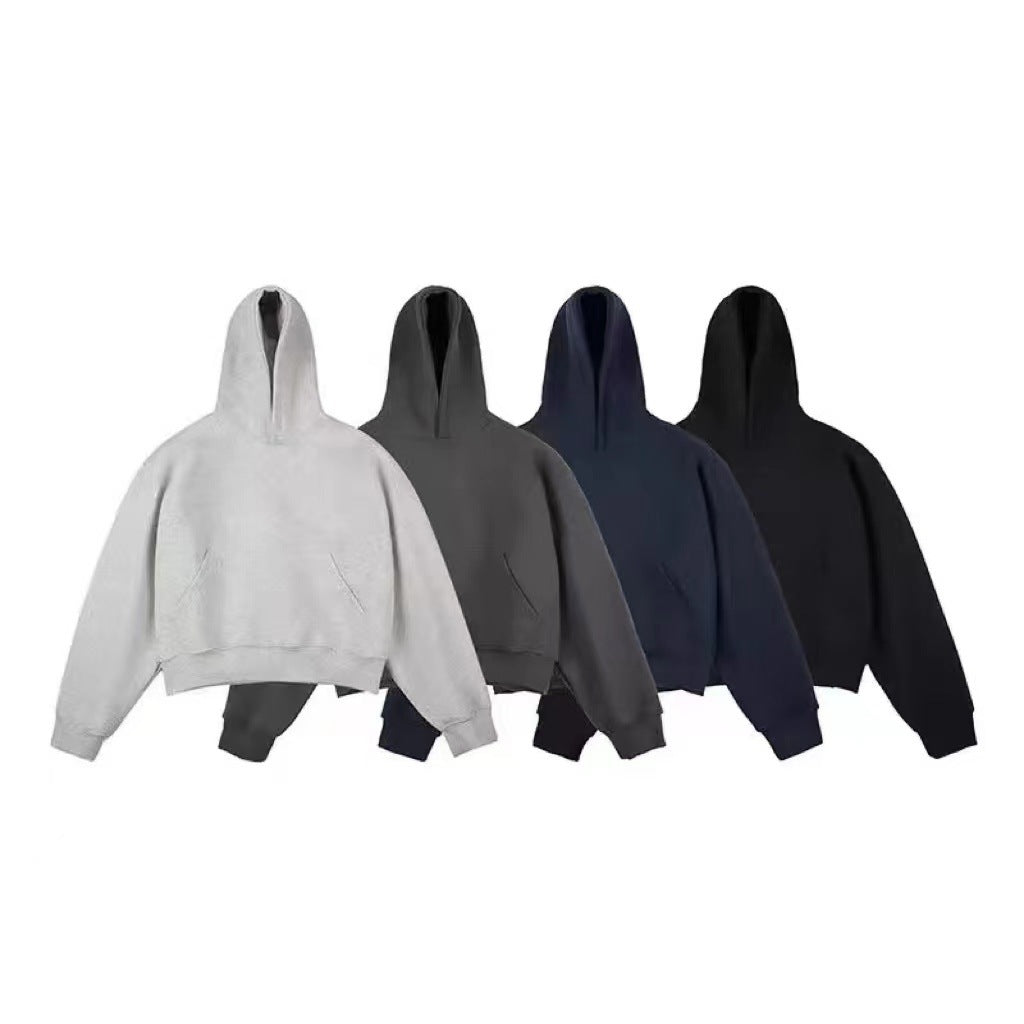 Four pullover hoodies in light gray, dark gray, navy and black arranged side by side on a white background