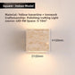 Iron framed travertine wall light glowing beside a wooden shelf at night