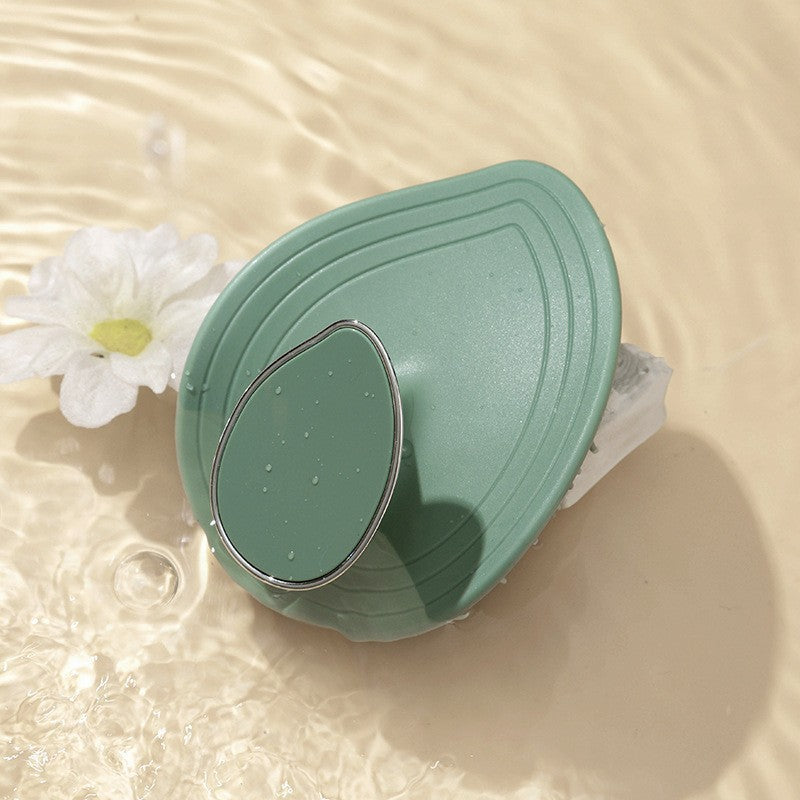 Gray leaf scalp brush lathering shampoo in wet hair