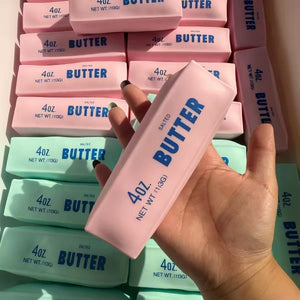 Strawberry pink squishy butter stick stress toys shaped like salted butter blocks held in a hand
