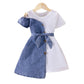 Girls' patchwork denim dress shown from an angled view