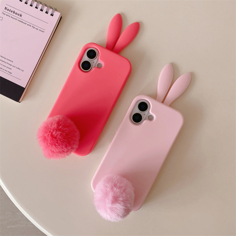 Deep pink and light pink rabbit iPhone cases laid flat with plush pom pom tails