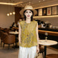 Front view of yellow jacquard sleeveless blouse with white wide-leg trousers