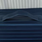 Ribbed stripe makeup organizer bag with a top handle and wrap around zip on a plain background