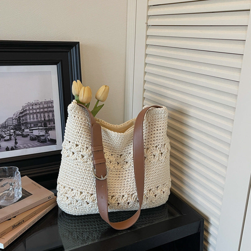 Off-white woven cotton bag styled on a table with tulips