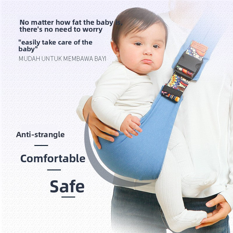 Parent wearing the baby carrier hip seat with the baby seated on the padded platform