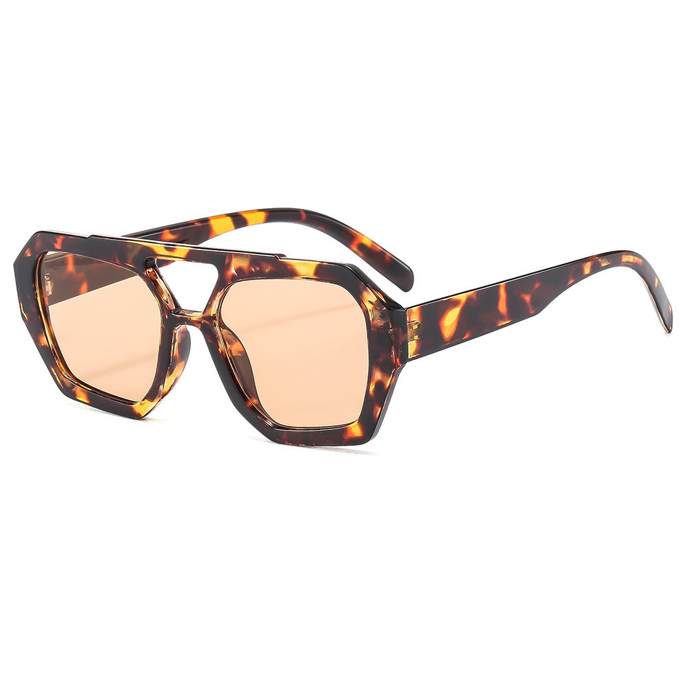 Top down view of polygonal sunglasses folded flat on a clean surface