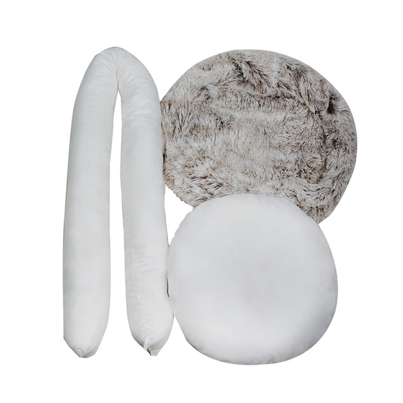 Round plush pet bed shown taken apart into its cover, bolster rim and cushion