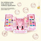 Open pink play makeup case with eyeshadow palettes, nail polish bottles and press-on nails beside a printed text panel