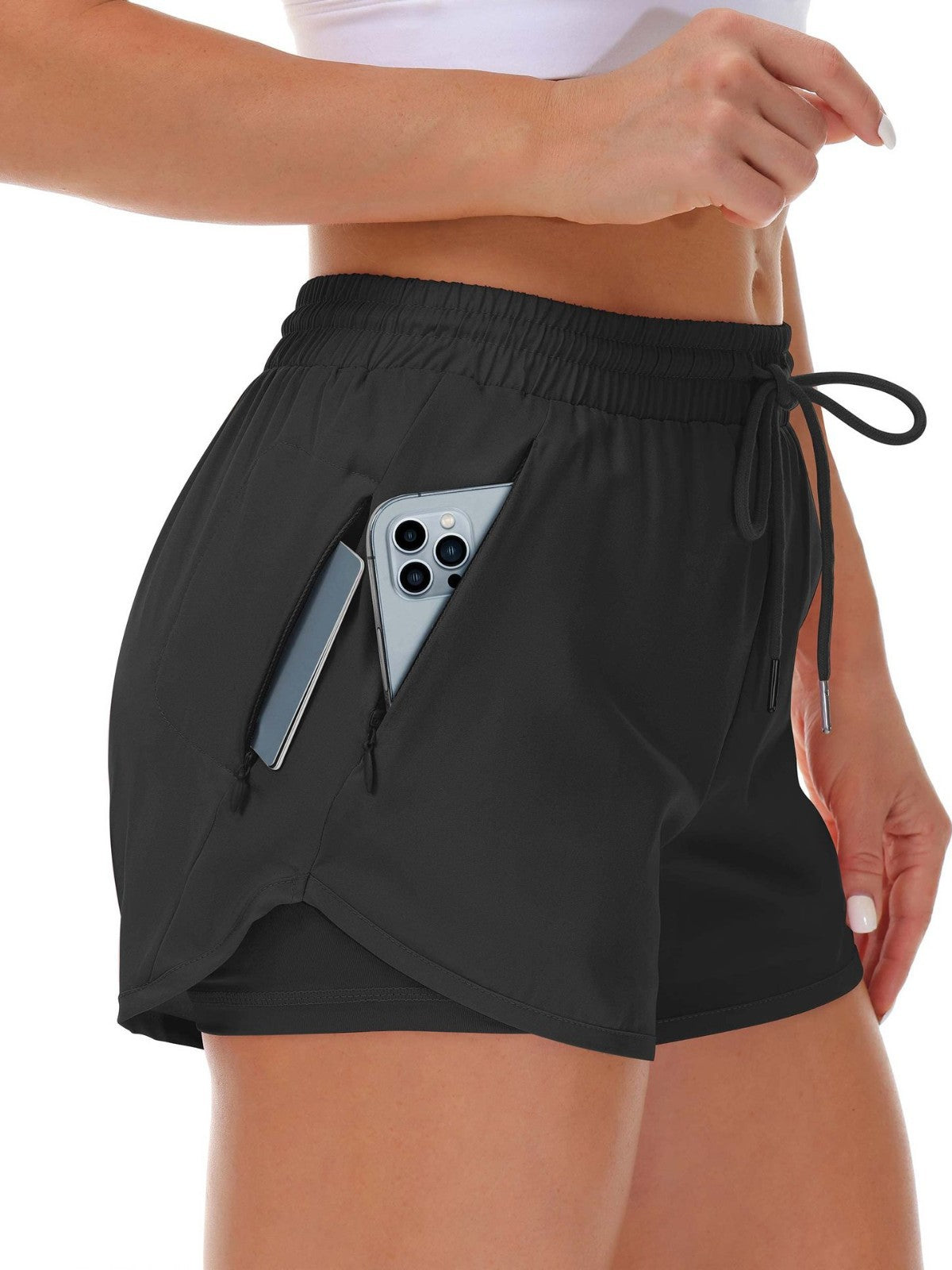 A black womens fitness shorts with drawstring elastic waistband, front view on model