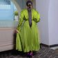 Olive green pleated maxi dress seen from the back, knife pleats falling from the belt