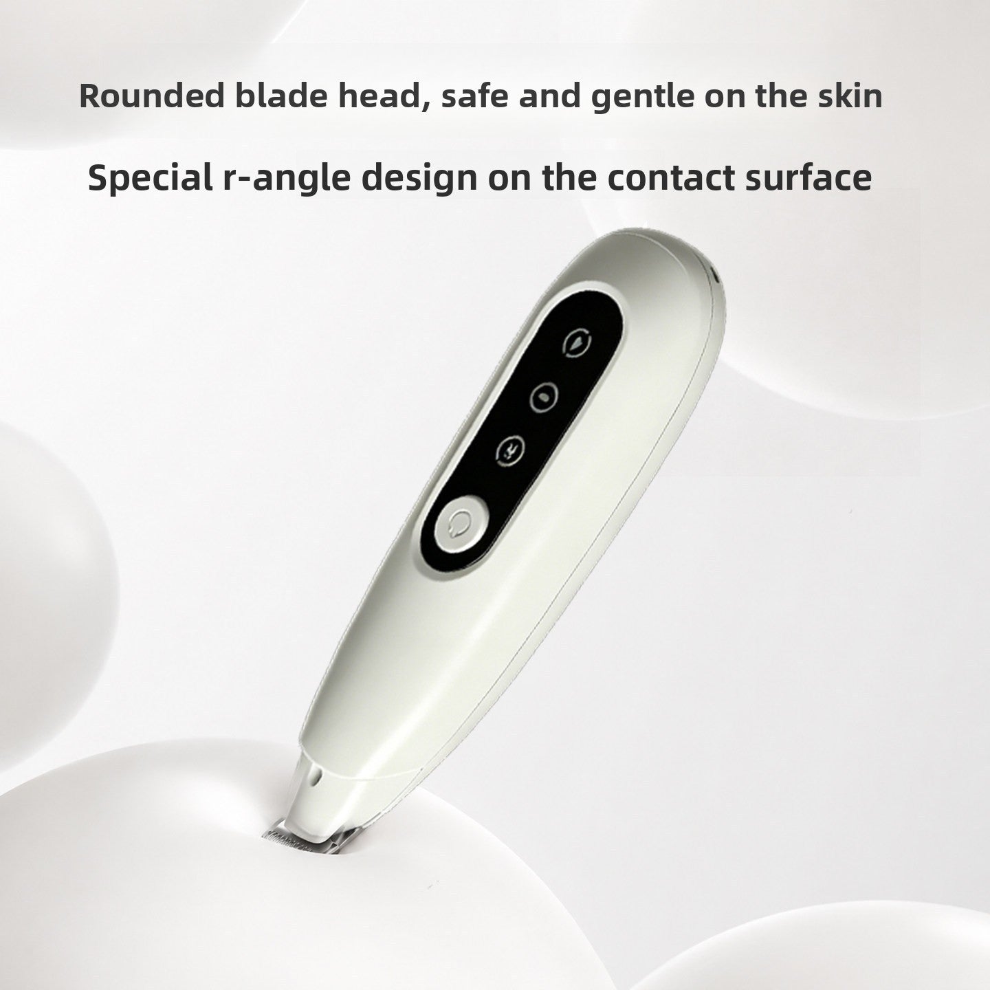 White pet grooming trimmer with a rounded safety blade head resting on a pale studio surface