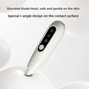 White pet grooming trimmer with a rounded safety blade head resting on a pale studio surface