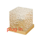 Clear rippled cube atmosphere lamp on a gold tone base projecting moving water light