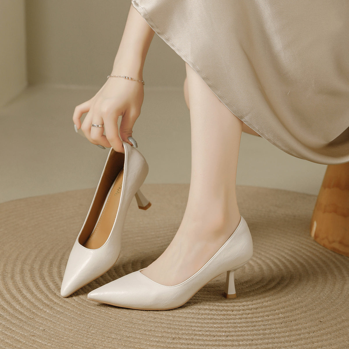 Beige pointed toe pumps with a 6 cm slim heel, one held in hand, Beige 6cm option, size 35