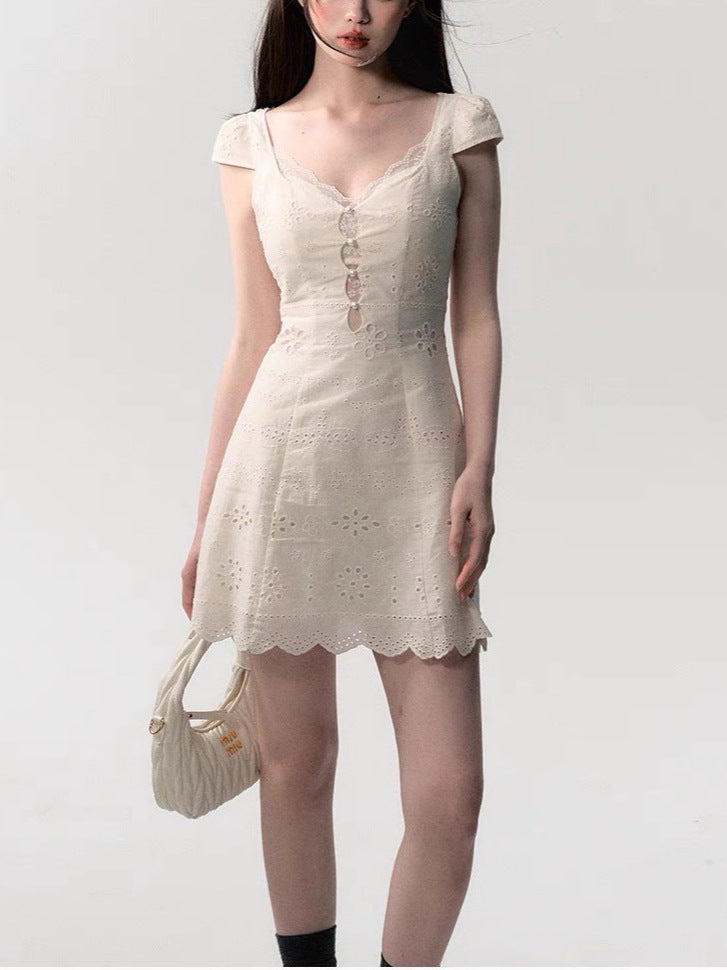 Angled view of the lace patchwork summer dress showing the light woven body and lace inserts