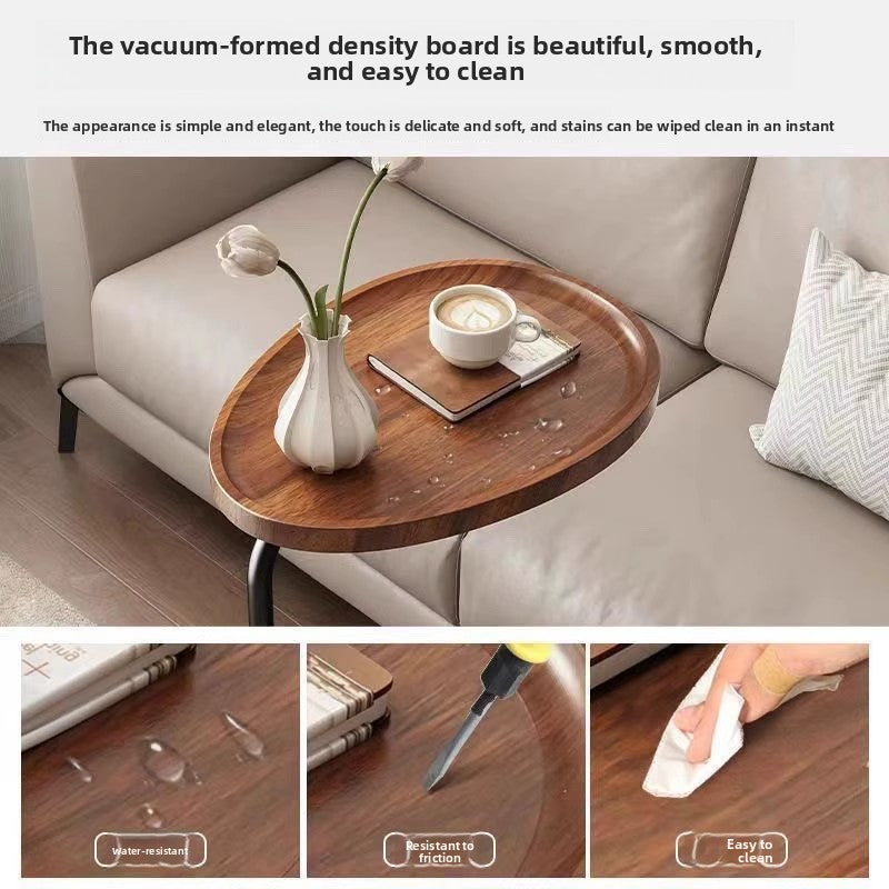 C shaped side table with a rounded oval top and a low T shaped metal base for small spaces