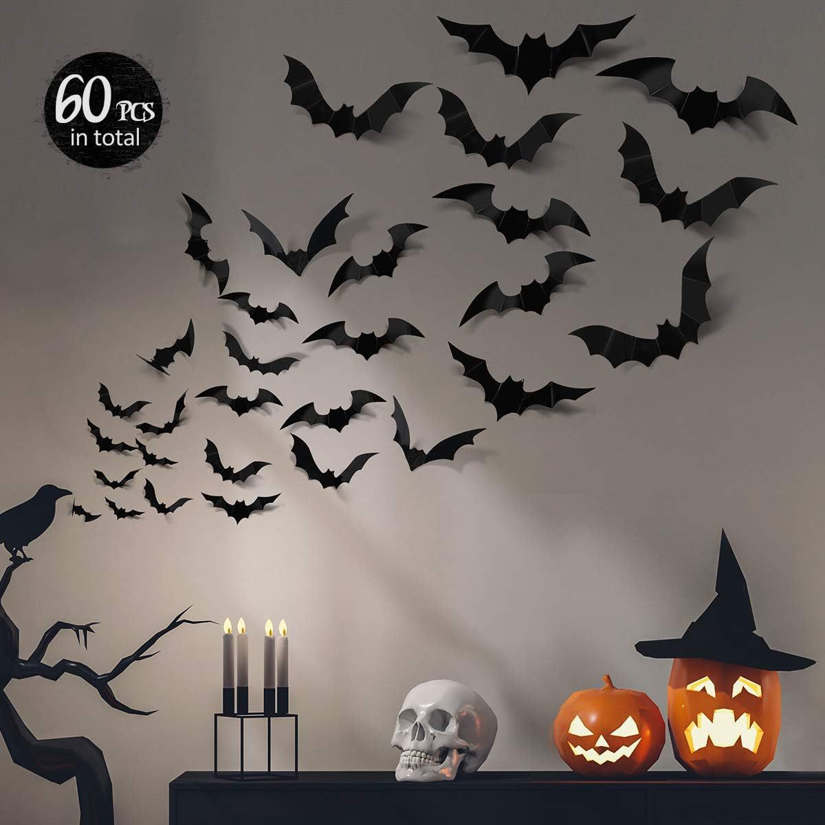Several black 3D bat stickers of different sizes scattered on a light wall