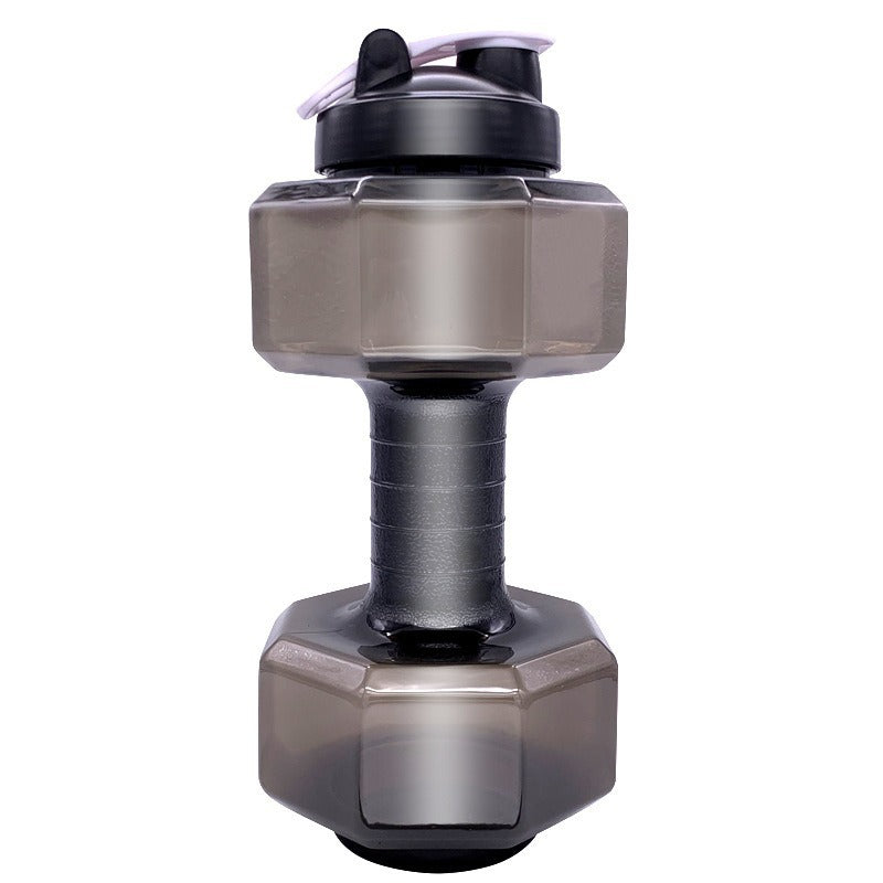 Fillable dumbbell bottle held at the grip with water visible through the clear wall